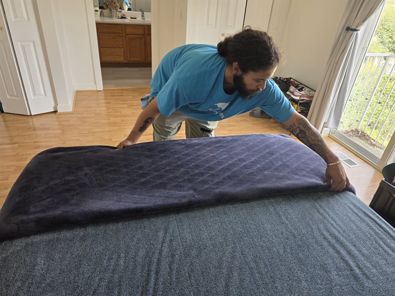 A Rain City Maids cleaner making a bed